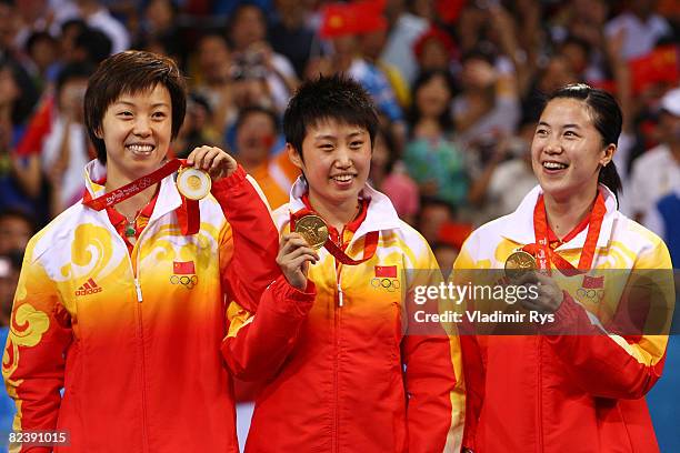 Guo Yue, Wang Nan and Zhang Yining of China pose after winning the gold medal in the Women's Team Gold Medal Contest table tennis event held at the...