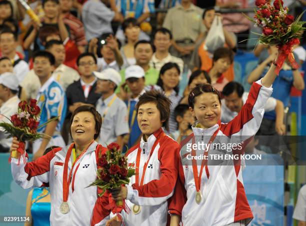 Singapore's table tennis team Wang Yue Gu , Feng Tianwei and Li Jia Wei pose with their silver medals in the women's team table tennis final match of...