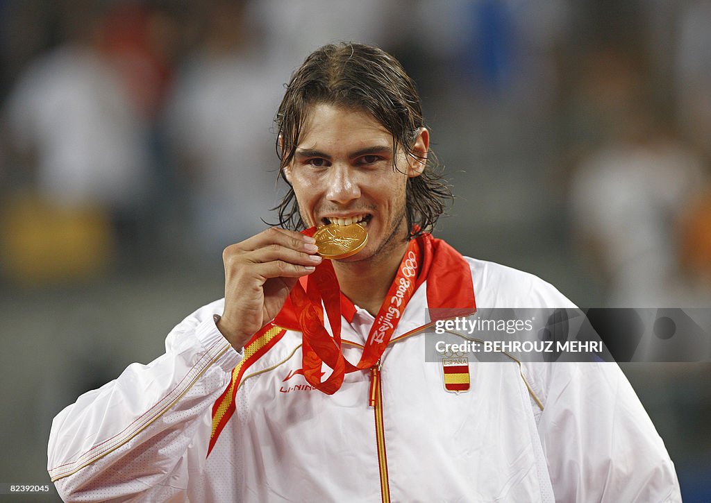 Gold medallist Rafael Nadal of Spain bit
