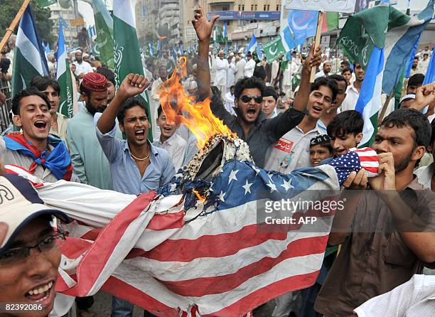 Activists of Jamaat-e-Islami, the main Islamic religious party of Pakistan torch an effigy of US President George W. Bush during a protest in Karachi...