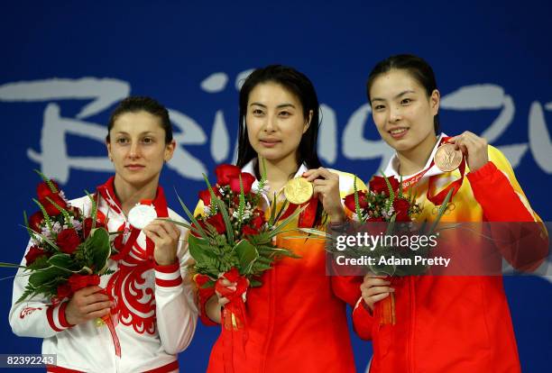 Silver medalist Julia Pakhalina of Russia, gold medalist Guo Jingjing of China and bronze medalist Wu Minxia of China poses with their medals after...