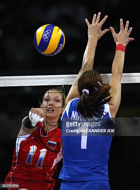 Russia?s Ekaterina Gamova smashes the ball against Jelena Nikolic of Serbia during their women's preliminary volleyball match of the 2008 Beijing...