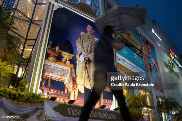 Large portrait of His Majesty the King Maha Vajiralongkorn is seen outside the Paragon shopping mall to celebrate his 65th birthday on Friday July...