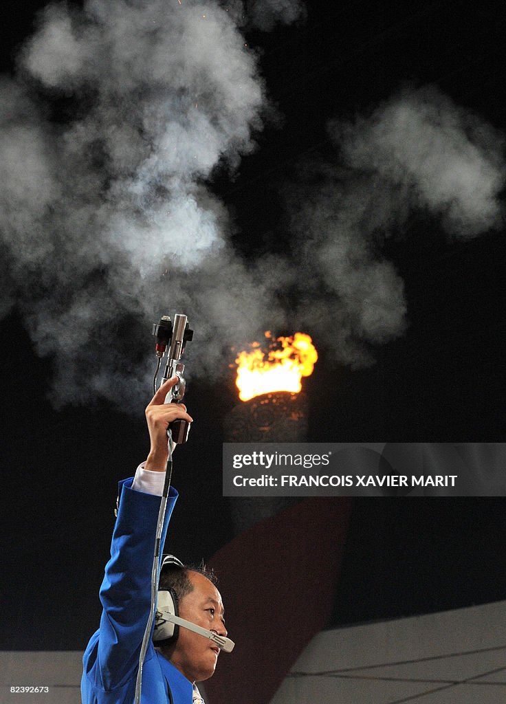 A referee fires the start gun during the