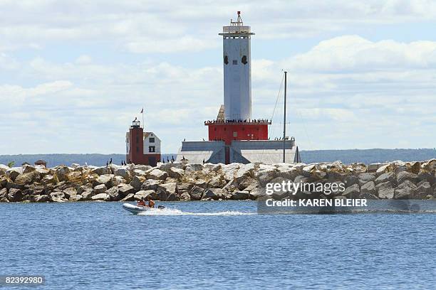 This July 28, 2008 photo shows the Round Island Light and the Round Island Passage light in the shipping lanes of the Straits of Mackinac, which...