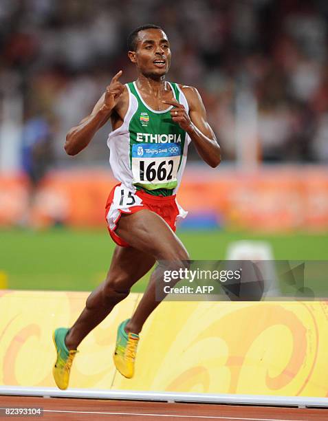 Ethiopia's Kenenisa Bekele celebrates as he runs to the finish line during the men's 10,000m final at the National Stadium as part of the 2008...