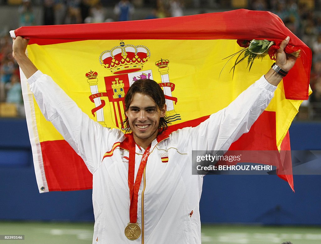 Rafael Nadal of Spain holds up the Spani