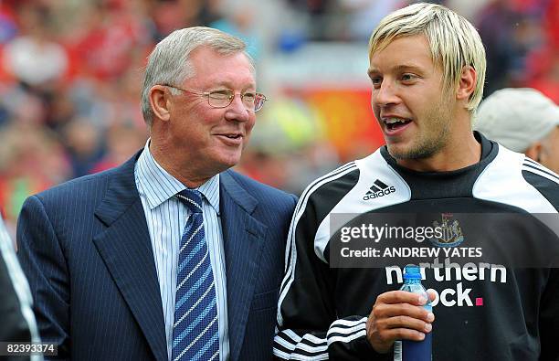 Manchester United manager Alex Ferguson chats to Newcastle United's English forward Alan Smith as he takes his seat before the English Premier league...