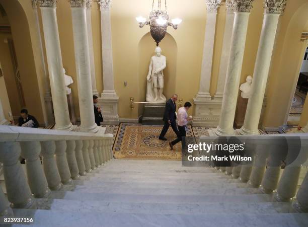 Senate Minority Leader Charles Schumer walks through the US Capitol on the morning after the GOP 'Skinny Repeal' health care bill failed to pass, on...