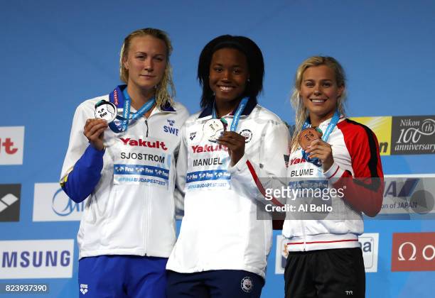 Silver medalist Sarah Sjostrom of Sweden, gold medalist Simone Manuel of the United States and bronze medalist Pernille Blume of Denmark pose with...