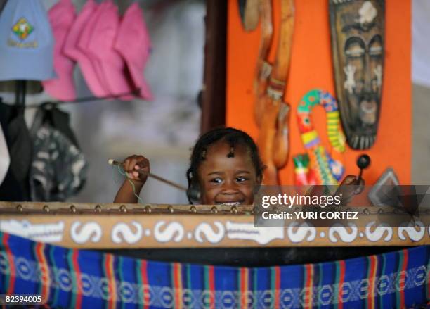 Young girl plays the marimba, one of Costa Rica's national symbols, at a souvernir shop in the town of Tarcoles, about 100 km southwest of San Jose,...
