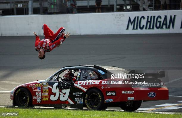 Carl Edwards, driver of the Office Depot Ford celebrates with a backflip from his car after winning the NASCAR Sprint Cup Series 3M Performance 400...