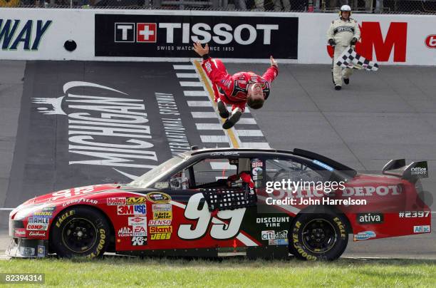 Carl Edwards, driver of the Office Depot Ford, celebrates by doing a back flip after winning the NASCAR Sprint Cup Series 3M Performance 400 at...