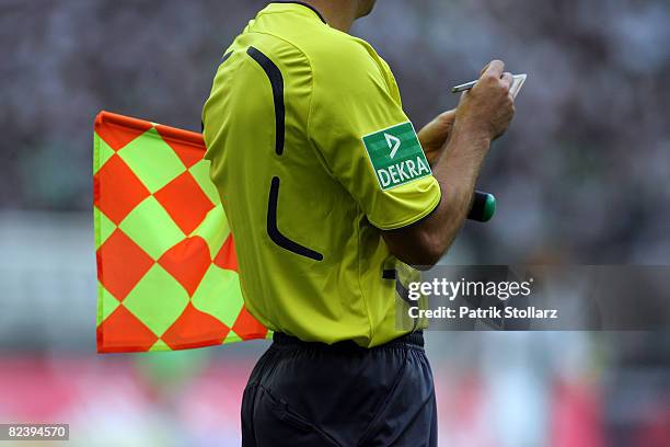 Linesmann notes a yellow card during the Bundesliga match between Borussia Moenchengladbach and VfB Stuttgart at the Borussia-Park on August 17, 2008...