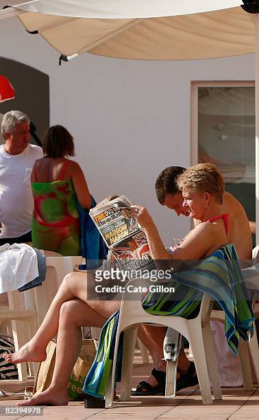 British tourist reads 'The Daily Mail' newspaper while relaxing in the sun at her hotel on August 17, 2008 in Santa Susanna, Spain. Feeling the pinch...