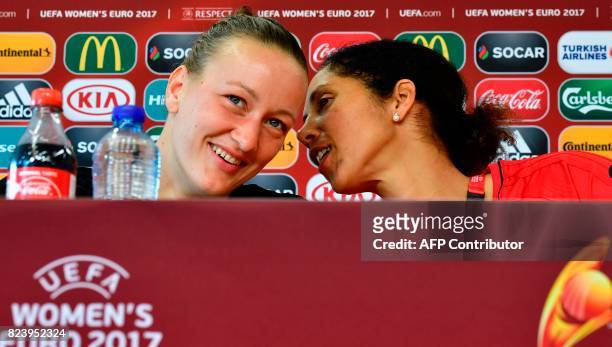 Germany's coach Steffi Jones whispers to Germany's goalkeeper Almuth Schult during a press conference at the Sparta Rotterdam Stadium during the UEFA...