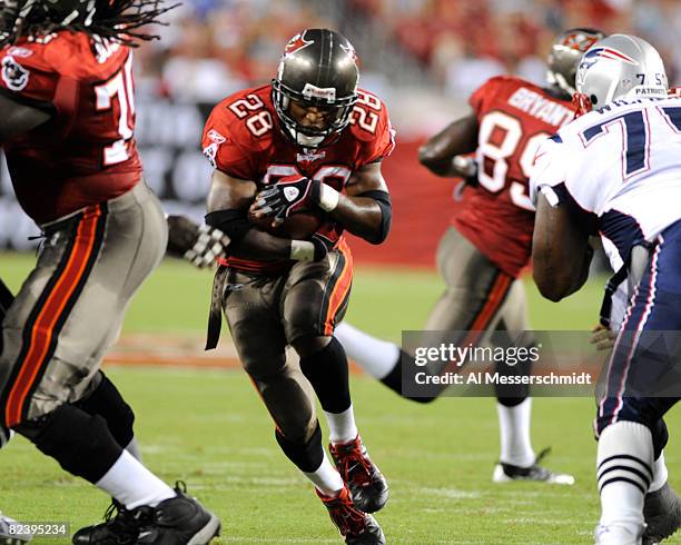 Running back Warrick Dunn of the Tampa Bay Buccaneers rushes upfield against the New England Patriots at Raymond James Stadium on August 17, 2008 in...