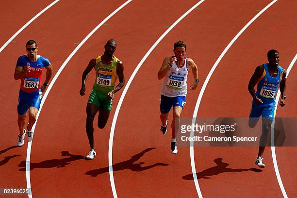 Essa Ismail Rashed of Qatar, Michael Blackwood of Jamaica, Andrew Steele of Great Britain and Michael Mathieu of Bahamas compete in the Men's 200m...