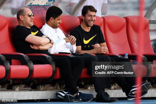 Paris Saint-Germain's Qatari president Nasser Al-Khelaifi speaks with Paris Saint-Germain's Portuguese sporting director Antero Henrique and deputy...