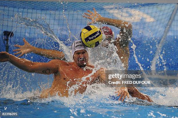 Hungarians Peter Biros and Zoltan Szecsi block the ball during their men's preliminary group B water polo match against Canada at the 2008 Beijing...
