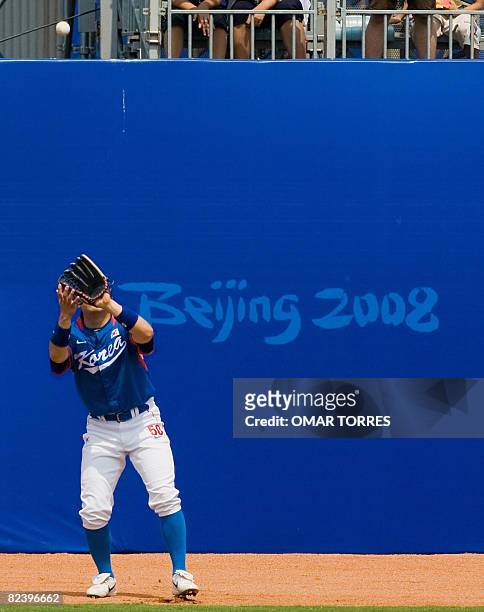 South Korean left fielder Kim Hyunsoo catches a flyout from a hitter of Chinese-Taipei during the second inning of the preliminary baseball game at...