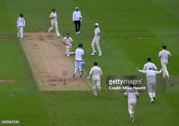 England team mates rush tocongratulate Jimmy Anderson of England after a return catch to dismiss Chris Morris of South Africa lbw during Day Two of...