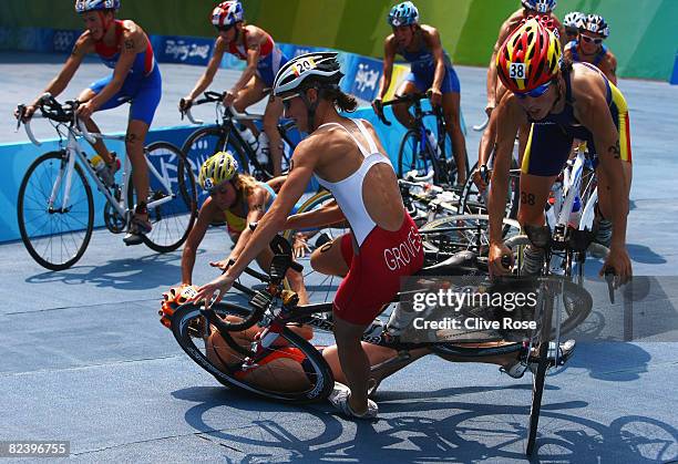 Lauren Groves of Canada, Ainhoa Murua of Spain and Ana Burgos of Spain crash during the cycling portion of the women's triathlon event at the...