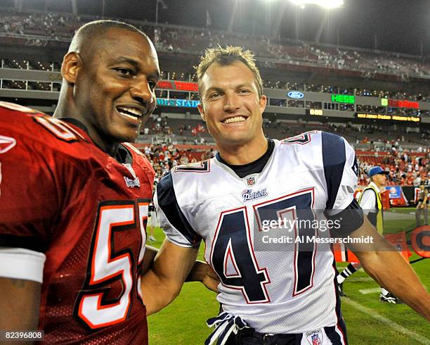 Defensive back John Lynch of the New England Patriots greets linebacker Derrick Brooks of the Tampa Bay Buccaneers after play at Raymond James...