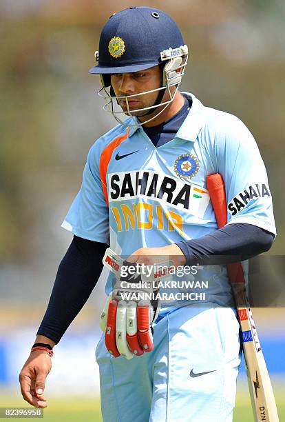 Indian cricketer Virat Kohli walks back to the pavilion after his dismissal during the first One Day International match between Sri Lanka and India...