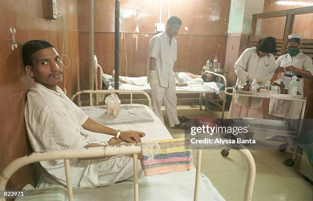 An HIV postitive patient sits on his bed February 20, 2001 at the J. J. Hospital in Bombay, India. The pharmaceutical company Cipla announced it will...