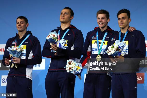 Gold medalists Great Britain pose with the medals won during the Men's 4x200m Freestyle final on day fifteen of the Budapest 2017 FINA World...