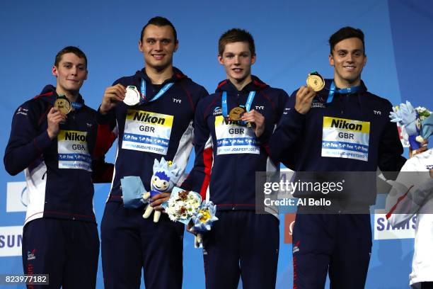 Gold medalists Great Britain pose with the medals won during the Men's 4x200m Freestyle final on day fifteen of the Budapest 2017 FINA World...