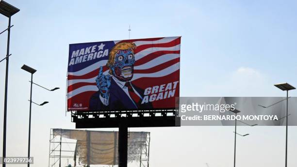 Billboard by US artist Mitch O'Connell depicting US president Donald Trump is displayed, in allusion and as a tribute to John Carpenter's 1988 cult...