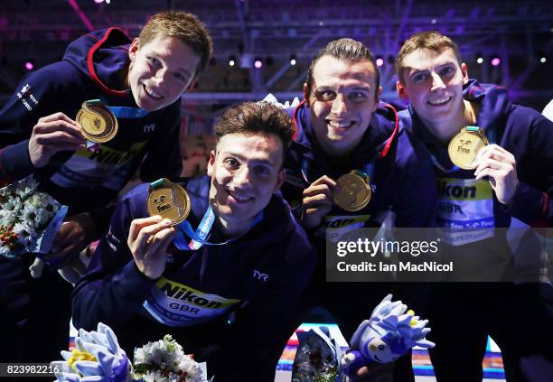 Duncan Scott, James Guy, Nicholas Grainger and Stephen Milne pose with their medals after Great Britain win the 4 x 200m Freestyle Relay during day...