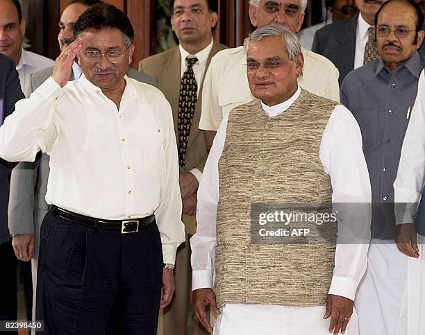 In this picture taken on July 15 Pakistani President Pervez Musharraf salutes the media as Indian Prime Minister Atal Behari Vajpayee looks on prior...