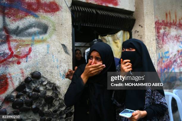 Palestinian relatives of 16 year old Abed Hussian Abu Hasimeh, who was shot dead by Israeli forces during clashes, cry during his funeral in the...