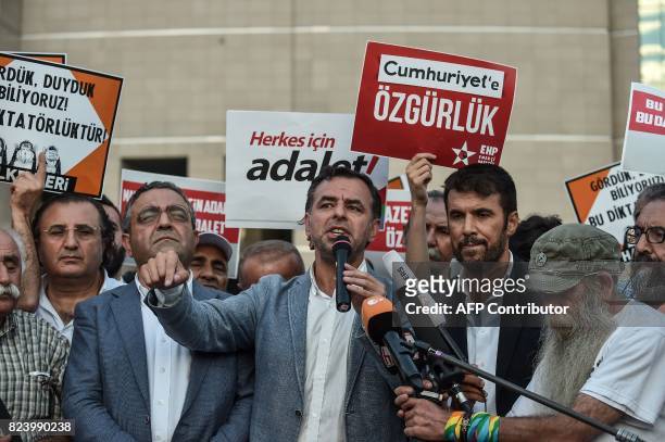 Turkish MPs Baris Yarkadas and Sezgin Tanrikulu of the main opposition Republic People's Party speak to the press in Istanbul on July 28, 2017 after...