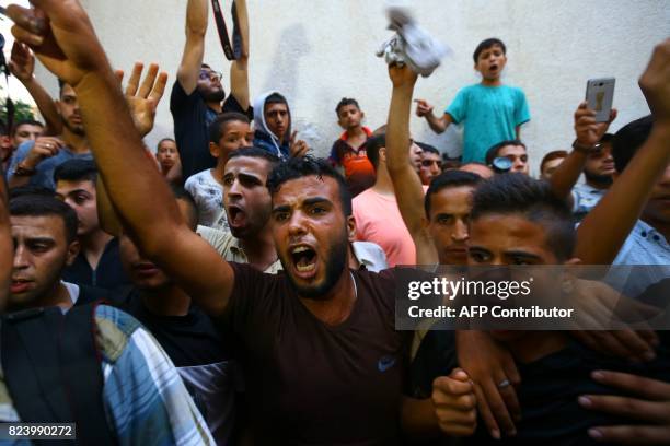 Palestinian men react during the funeral of 16 year old Abed Hussian Abu Hasimeh, who was shot dead by Israeli forces during clashes, in the Bureij...