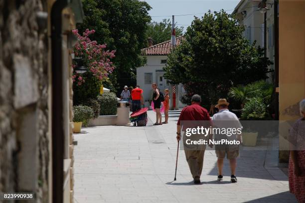 Elderly people are seen in the village of Omisalj on the island of Krk in Croatia on 28 July, 2017.