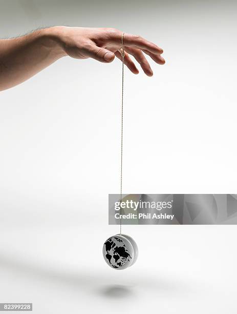 man playing with a yoyo globe - yo yo stock pictures, royalty-free photos & images