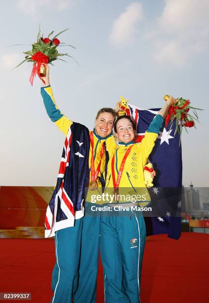 Tessa Parkinson and Elise Rechichi of Australia celebrate with their gold medals after winning the Women's 470 class event held at the Qingdao...