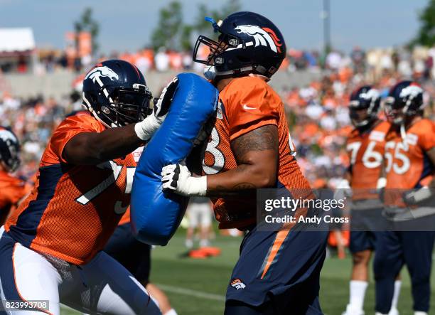 Denver Broncos offensive tackle Menelik Watson, left, and Elijah Wilkinson, #68, during drills at Dove Valley July 28, 2017.