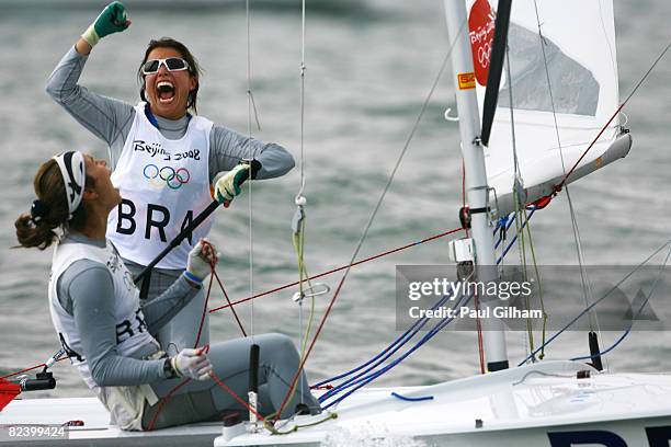 Fernanda Oliveira and Isabel Swan of Brazil celebrate finishing third overall following the Women's 470 class medal race held at the Qingdao Olympic...