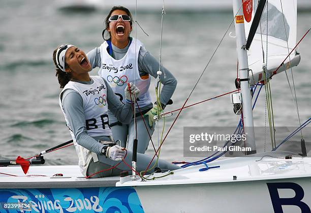 Fernanda Oliveira and Isabel Swan of Brazil celebrate finishing third overall following the Women's 470 class medal race held at the Qingdao Olympic...