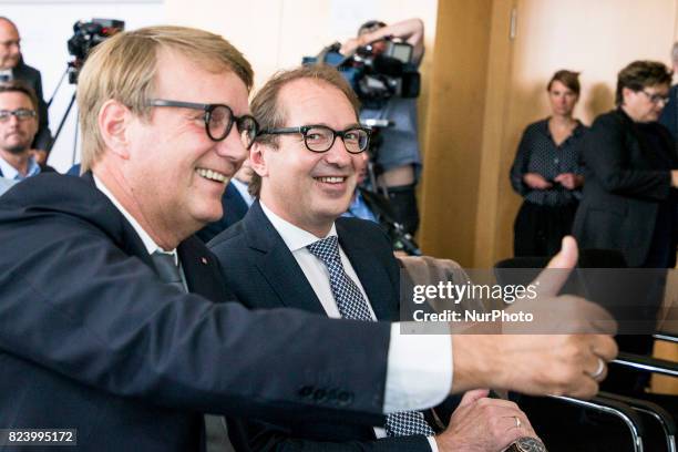 German Transport Minister Alexander Dobrindt and Deutsche Bahn Infrastructure Manager Ronald Pofalla gesture for the photographers prior to a news...