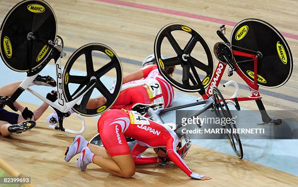 Track cyclist Satomi Wadami of Japan, Trine Schmidt of Denmark and Sarah Hammer of the US fall during the 2008 Beijing Olympic Games women's points...
