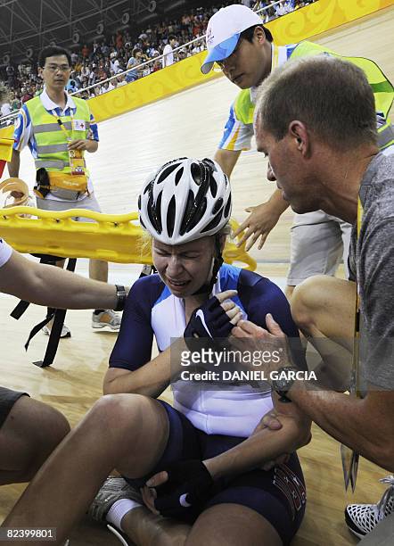 Track cyclist Sarah Hammer of the US cries after a fall also involving Satomi Wadami of Japan and Denmark's Trine Schmidt in the 2008 Beijing Olympic...