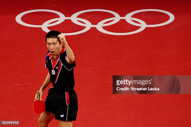 Seung Min Ryu of Korea celebrates scoring a point during their table tennis match at the Peking University Gymnasium on Day 10 of the Beijing 2008...