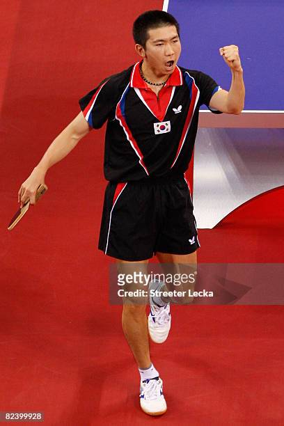 Seung Min Ryu of Korea celebrates scoring a point during their table tennis match at the Peking University Gymnasium on Day 10 of the Beijing 2008...