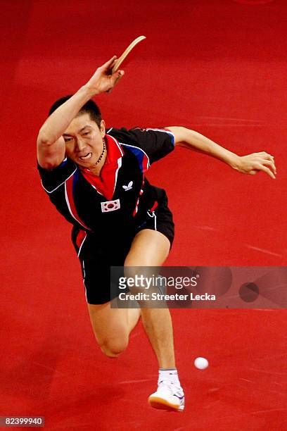 Seung Min Ryu of Korea hits a shot during their table tennis match at the Peking University Gymnasium on Day 10 of the Beijing 2008 Olympic Games on...